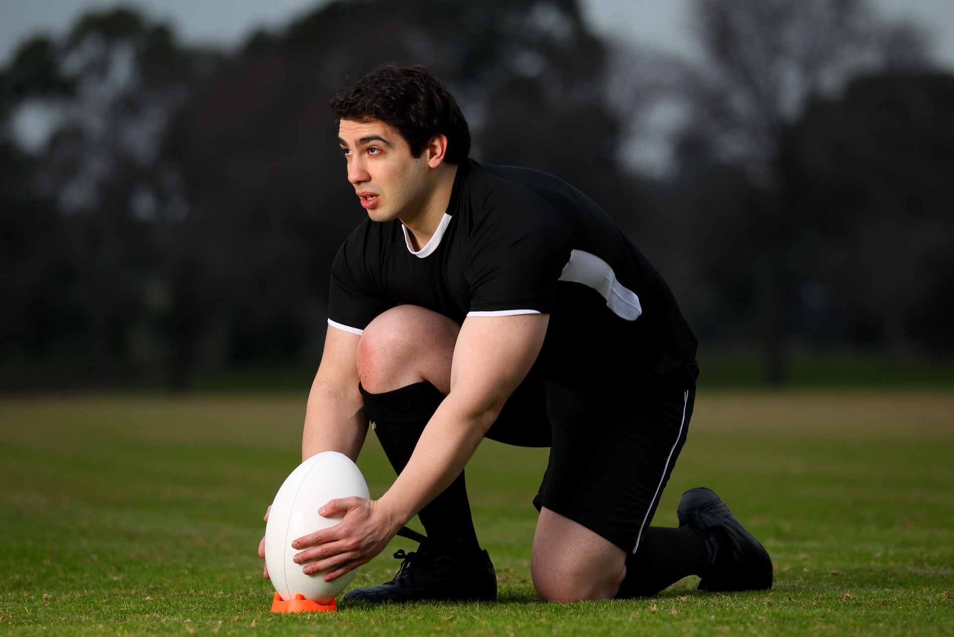 Rugby Player lines up a kick